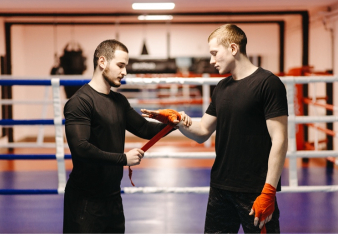 two men in gym wrapping hands